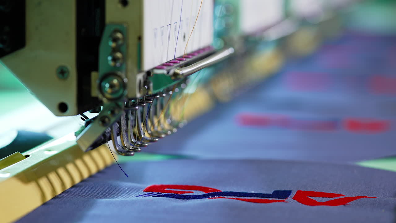 Needle of a sewing machine makes a thread stitches. Sewing needle of automatic sewing machine moving rapidly. Close-up.