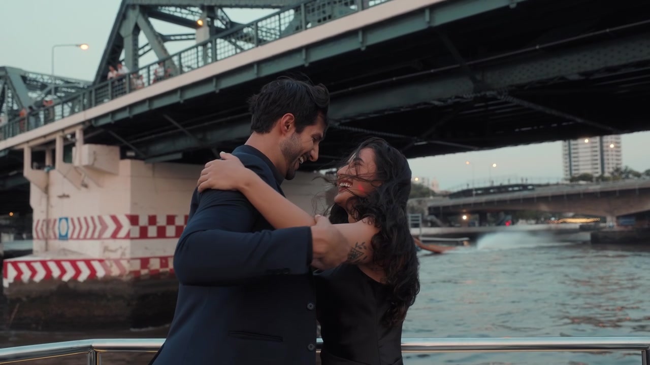 Romantic Couple Dancing and Hugging on a River Boat at Dusk