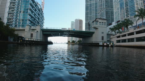 view from a small boat as it approaches a bridge on a narrow waterway in miami florida