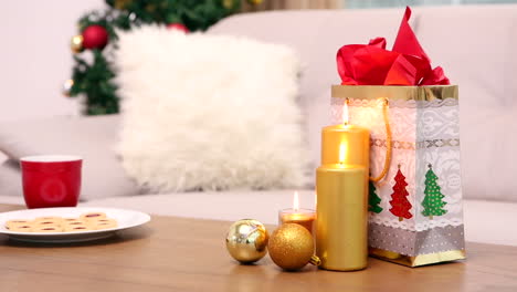 coffee table with christmas gift bag and cookies