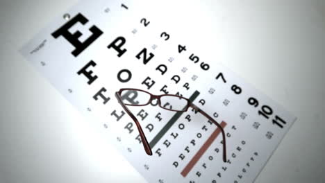 black reading glasses falling onto eye test