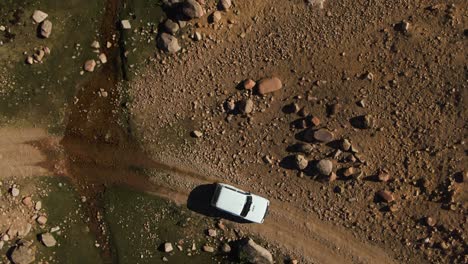 topdown of car crossing rough and rocky road at arashan lakes, namangan, ferghana valley, uzbekistan