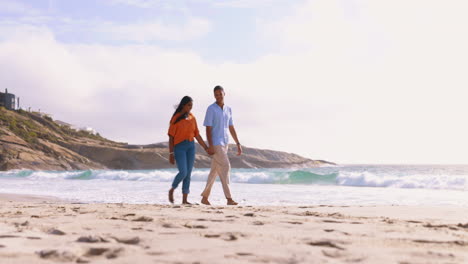 Couple,-beach-and-holding-hands-on-walk-together