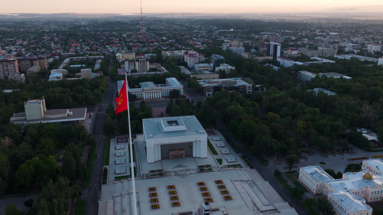 Fluttering Kyrgyzstan Flag On Ala-Too Central Square At Sunrise In Bishkek, Kyrgyzstan. Aerial Drone Shot