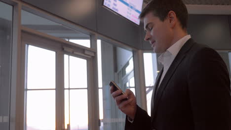 businessman chatting on the phone at airport