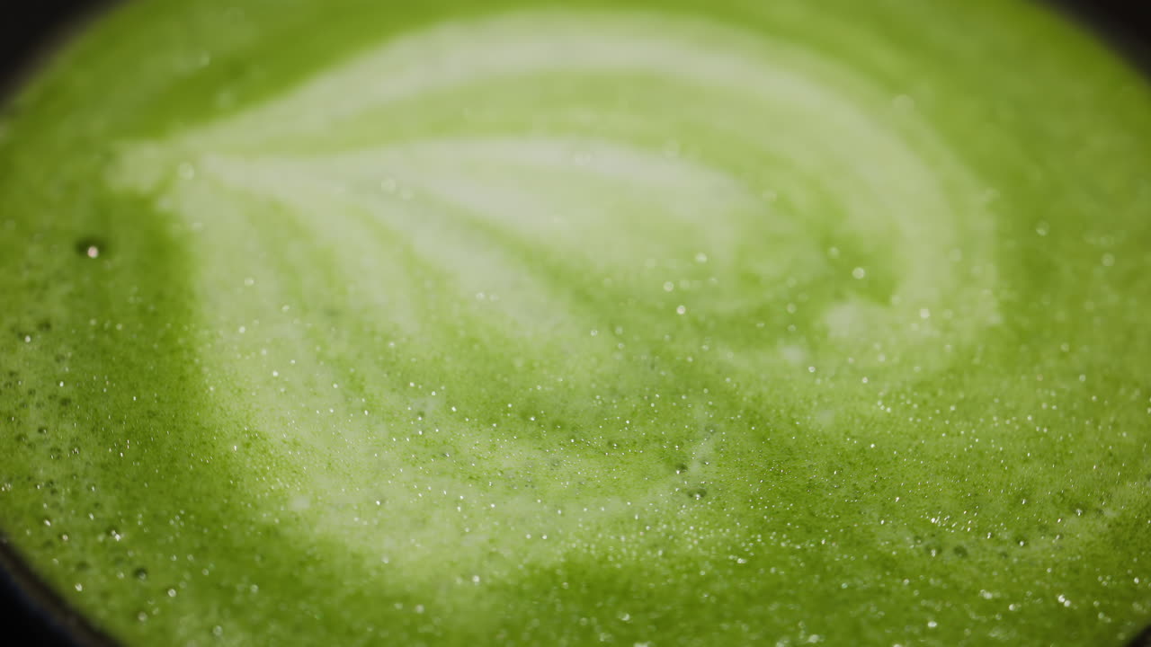 Close up of a matcha latte on a tray at a cafe