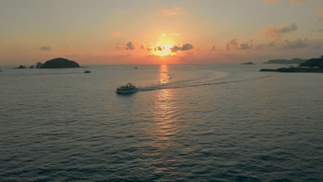 drone: boat at sunset in the sea