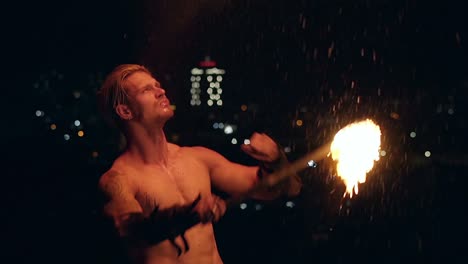 Young-blond-male-breathes-out-large-stream-of-fire-making-fireball-Slow-motion-shot