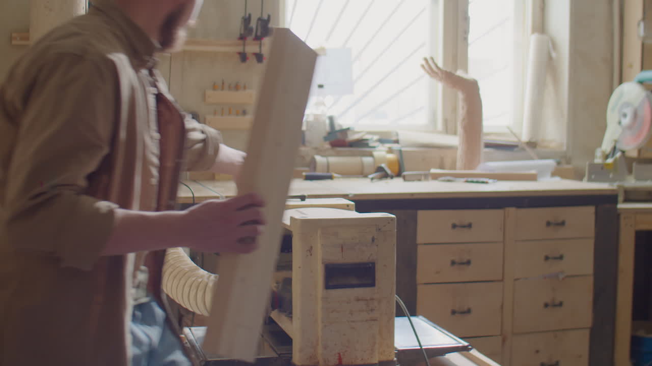 Carpenter Working with Thickness Planer
