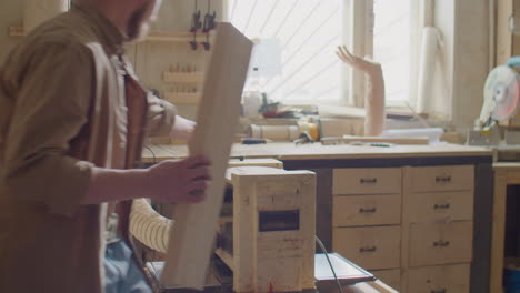 carpenter working with thickness planer