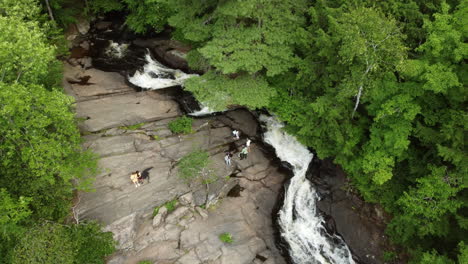 aerial overhead view of locals relaxing on granite rocks beside stubb's falls in arrowhead provincial park