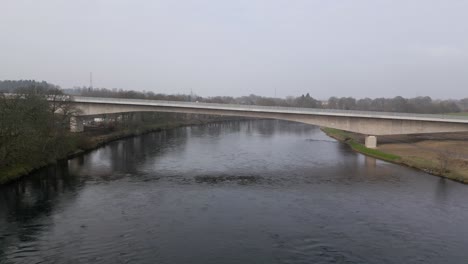 aerial view of the newly build bridge across river tay. drone descending camera tilting up