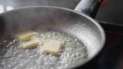 melting butter is tossed in a pan