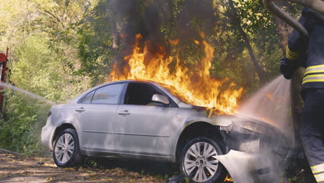 burning car extinguished by firefighters