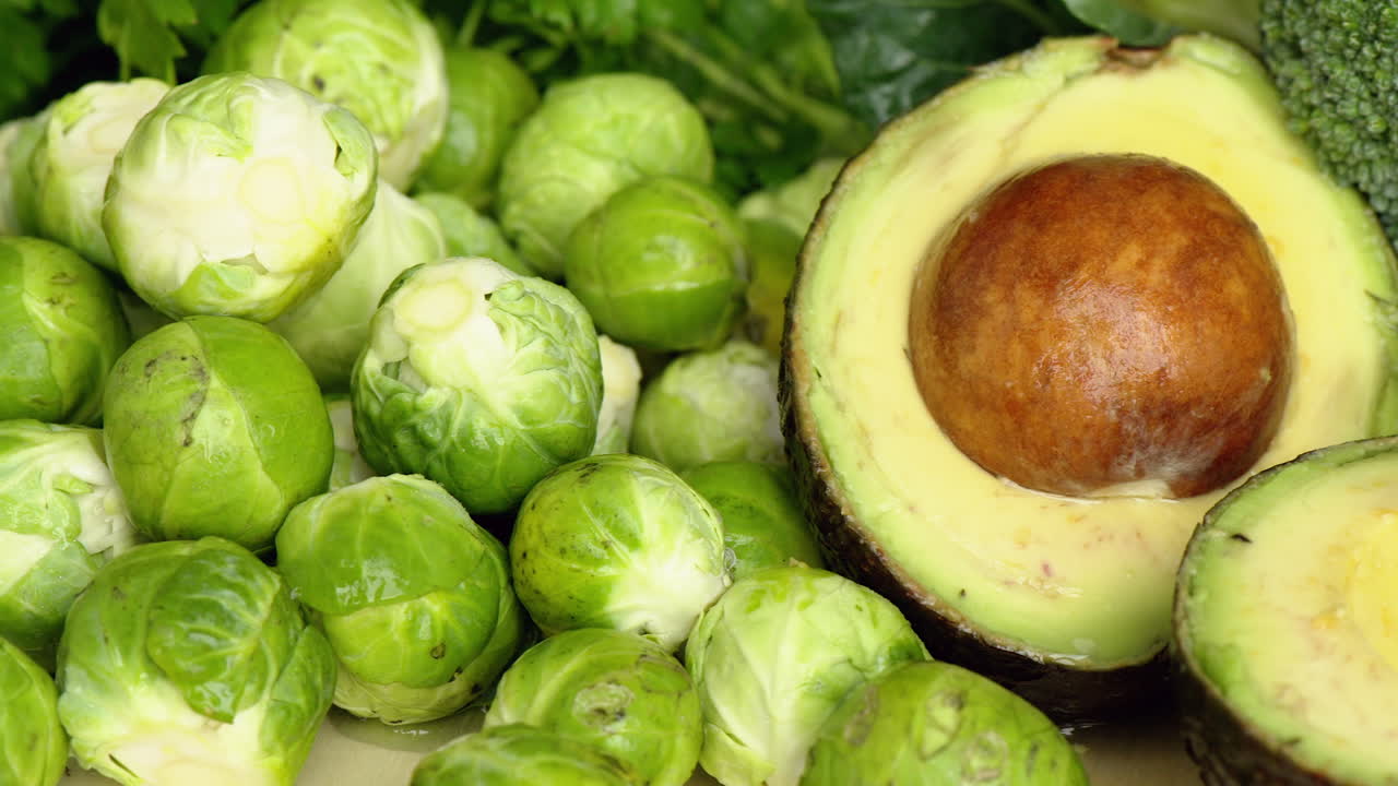 Green composition with avocado and salad, cabbage, macro close up