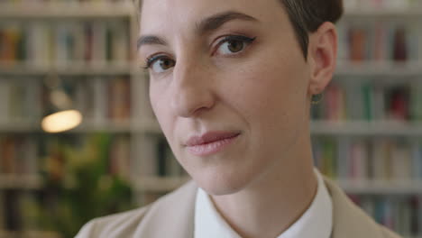 close up portrait of young pensive business woman thinking serious turns head looking at camera confident ambitious female entrepreneur in bookshelf background