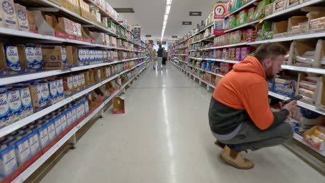 man shopping in supermarket aisle