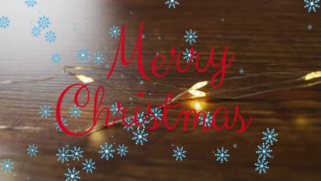 Animation-of-merry-christmas-over-wooden-background-with-snowflakes