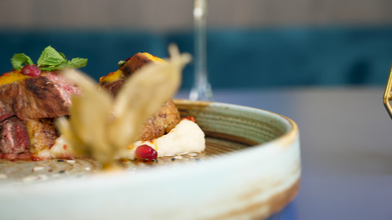 Gourmet Dish with Meat, Fruits, and Decorations