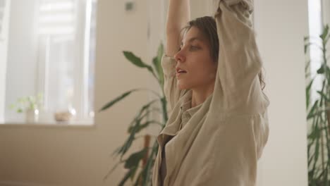 woman practicing yoga at home