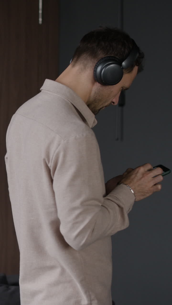 Man with Headphones Using Smartphone