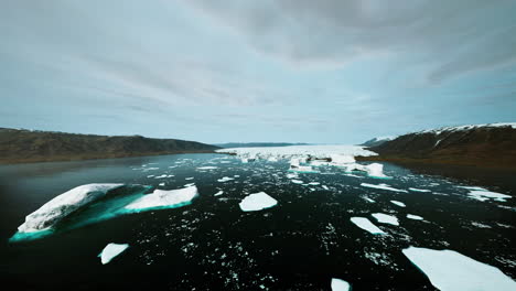 snowy mountains and drifting icebergs in the greenland sea