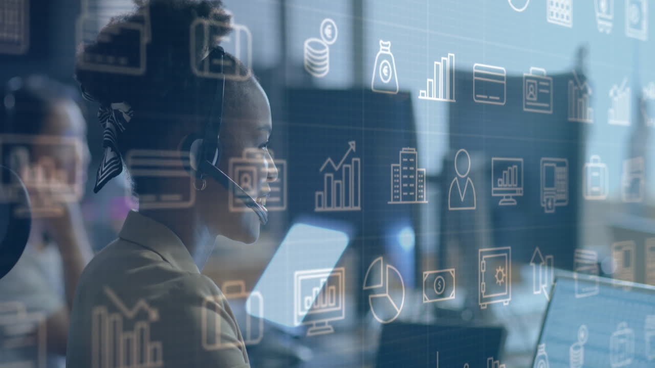 Animation of business icons over african american businesswoman using headset and laptop at office