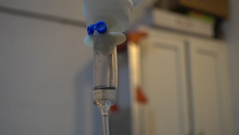 Close-up-bokeh-shot-of-intravenous-fluids-dripping-through-a-chamber-at-a-vets