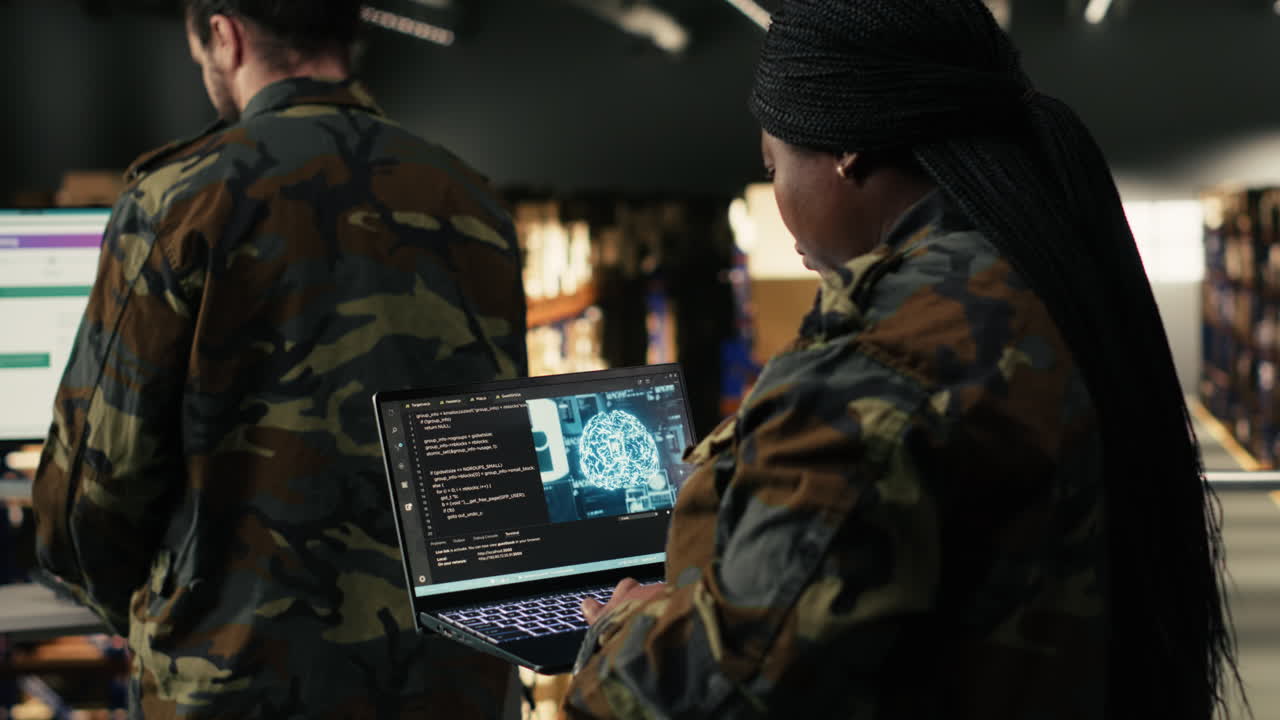 Female Soldier Programming on Laptop in Server Room