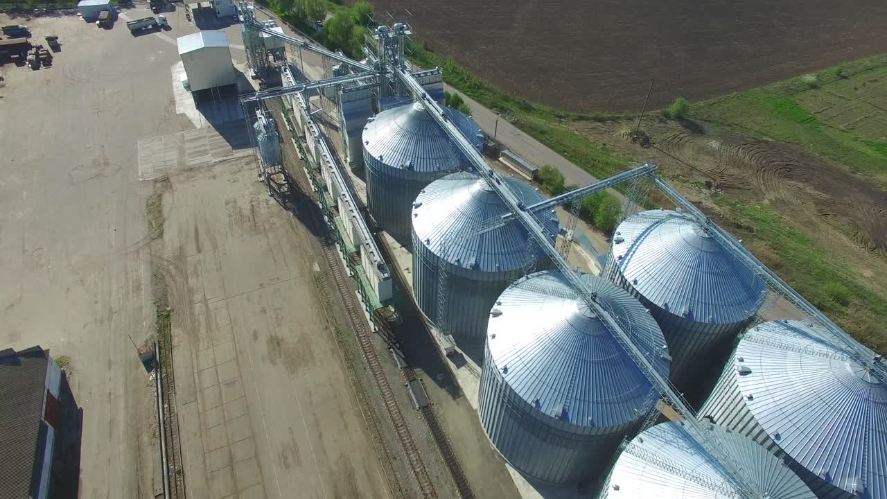 Grain Elevators And Granaries. Aerial view of big grain elevators in sunny summer day