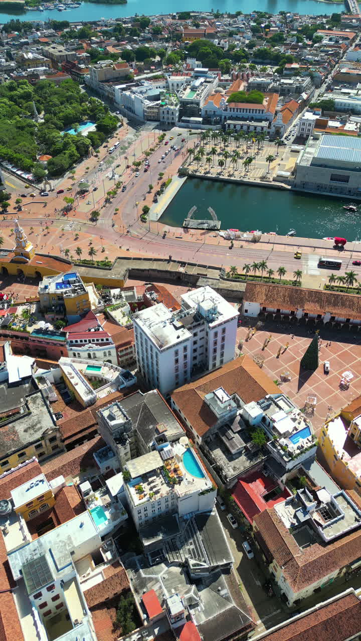 Aerial drone view of the historic center of Cartagena, Colombia alongside the Caribbean coast and promenade in daylight. Vertical