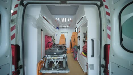 inside the ambulance, view from the sanitary compartment. different medical equipment and a stretcher.