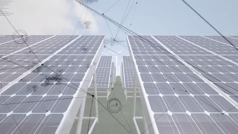 animation of moving lines and electrocardiograms over solar panels and wind turbines