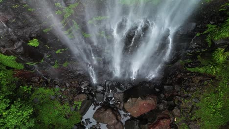 Ascending-up-a-rushing-waterfall-running-deep-into-a-tropical-rainforest-tourist-attraction