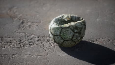 old soccer ball the cement floor