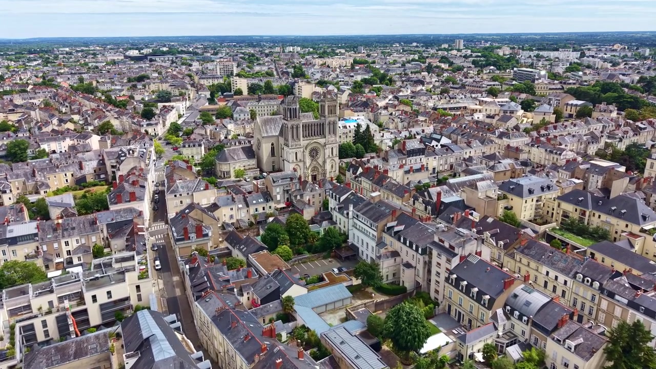 Drone che vola sopra il centro di Angers verso la Chiesa di Saint Joseph con una vista aerea panoramica della storica città circostante