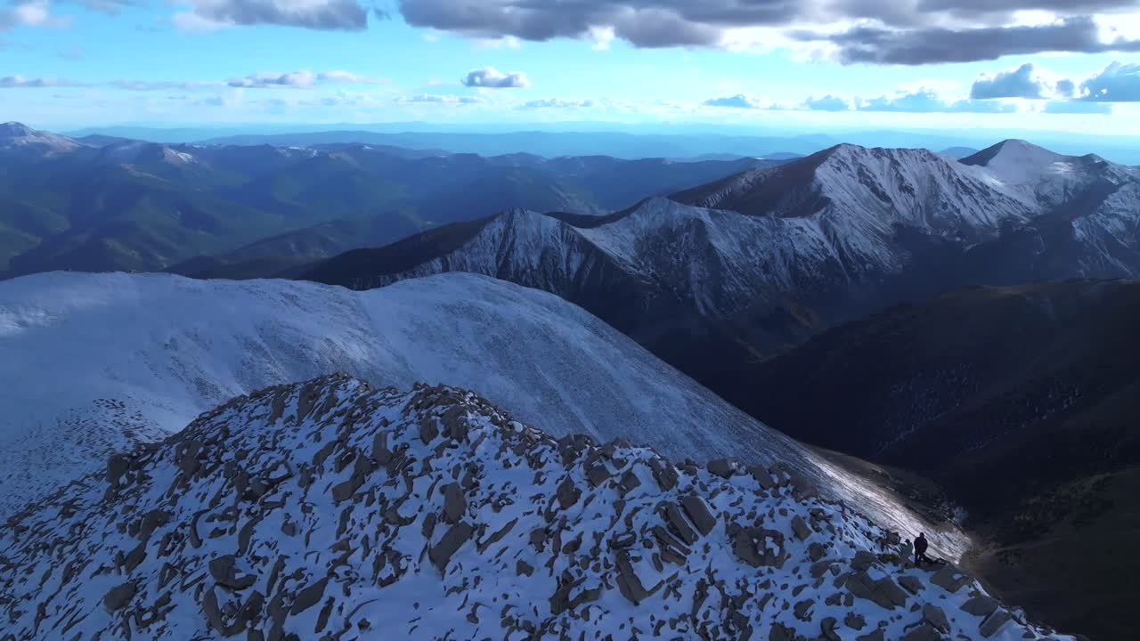Mt Mount Shavano snow covered dusting summit of Tabeguache Huron Peak aerial drone Colorado shaded blue hour Rocky Mountains Mt Elbert Sawatch Range above treeline fall autumn forward pan up motion