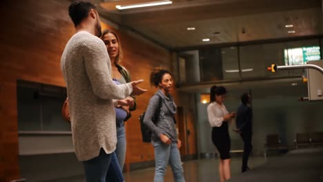 couple waiting for their luggage at baggage claim area 4k