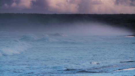 massive blue waves roll into the coast of hawaii in slow motion