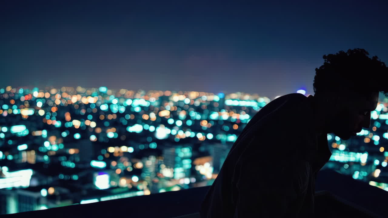 Man on rooftop at night