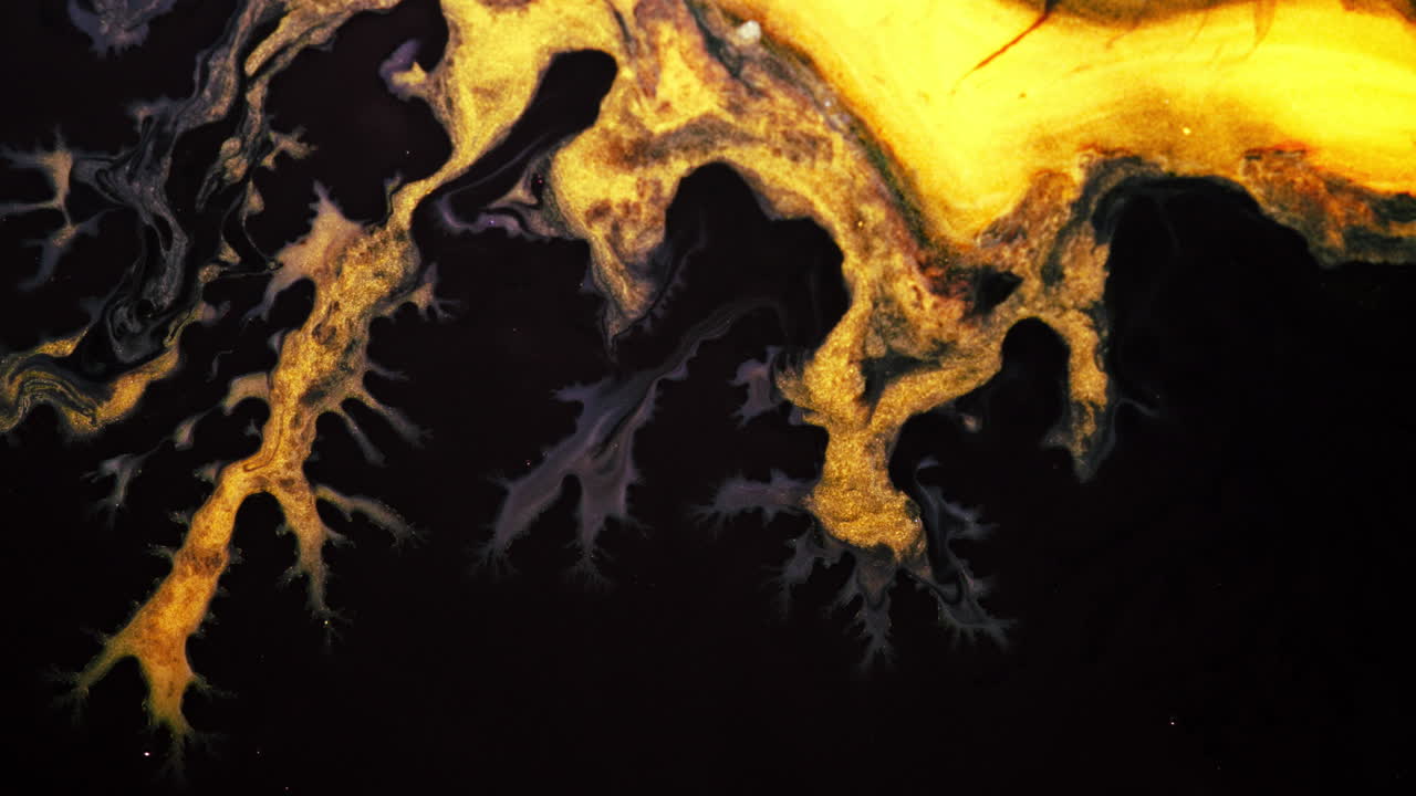 Substances blending and swirling together in vibrant colors, captured in macro detail