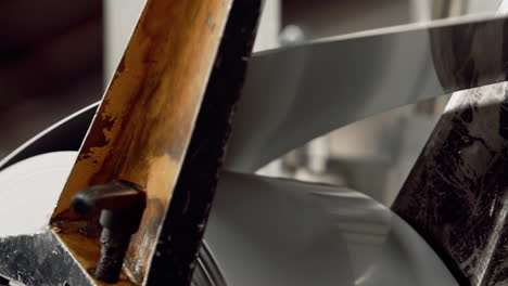 close up of sheet metal being pulled off a roll in a factory