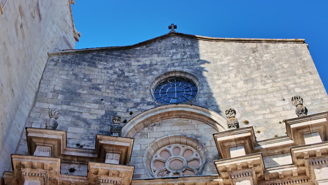 Saint-Sauveur Church, stone facade, rose window, La Rochelle, France. Low-angle pov