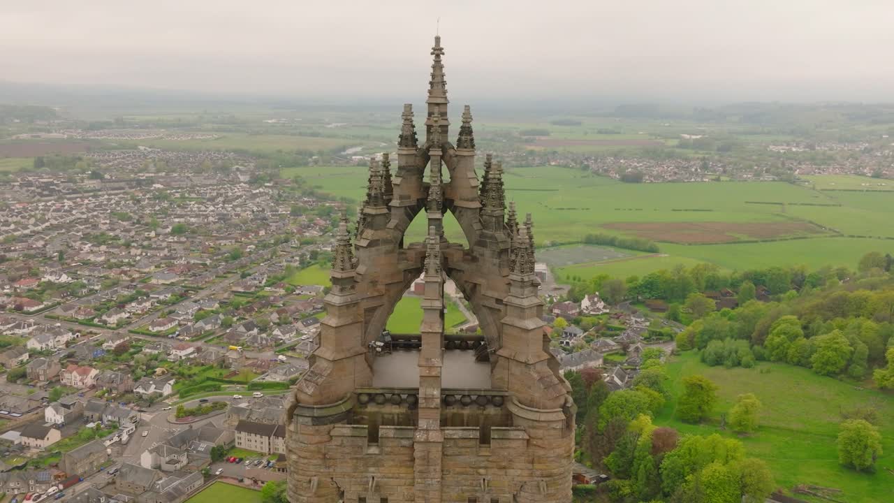 Aerial drone footage of The National Wallace Monument in Stirling, Scotland. Captured in dramatic light with sweeping views of the historic tower, surrounding landscape, and distant Highlands