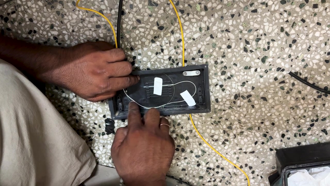 Fiber Optic Technician Performing Precision Cable arrangement In Equipment for network