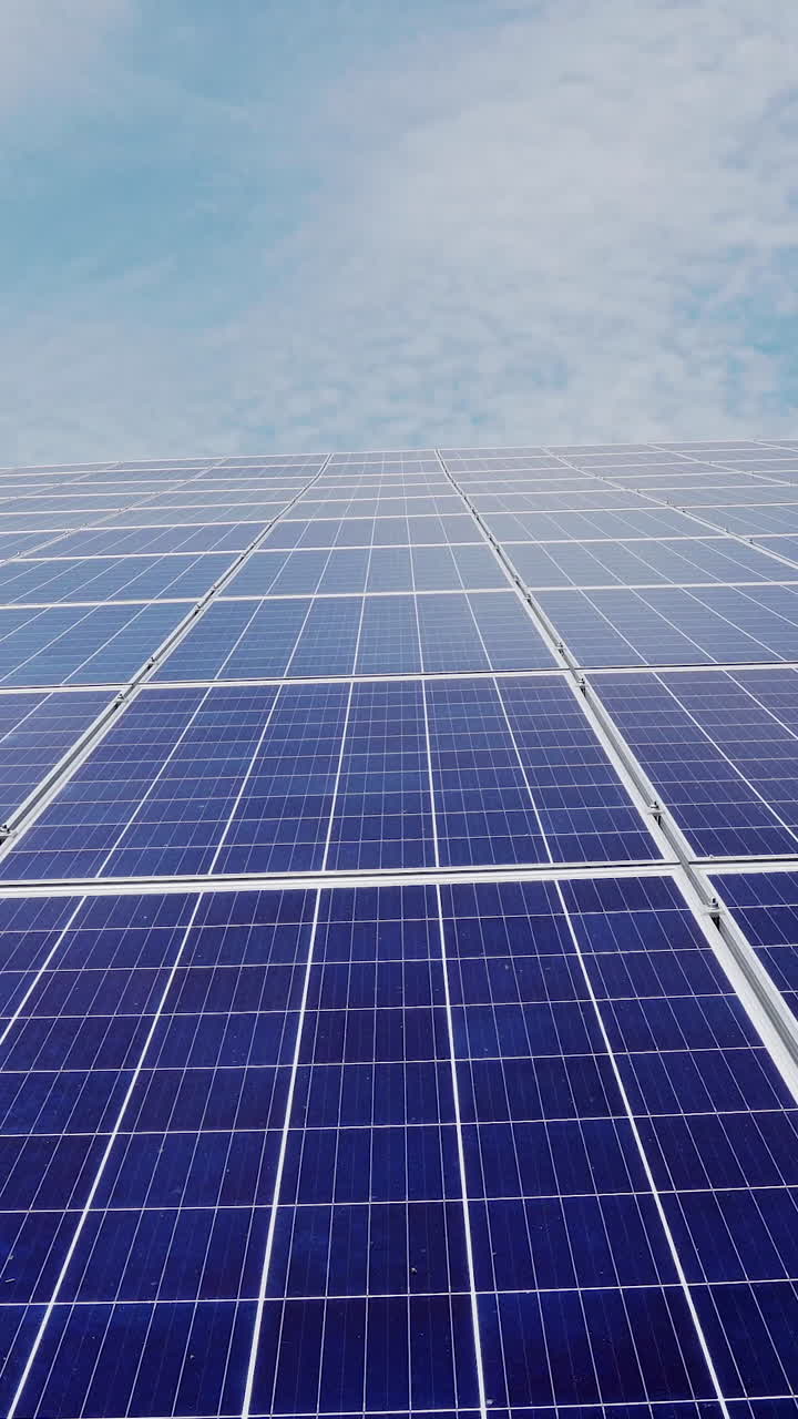 Solar power station. solar panels on a background of blue sky with clouds. Vertical video