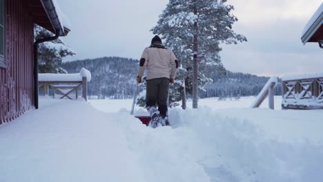 A-Man-Is-Removing-Ice-Using-Sleigh-Snow-Shovel