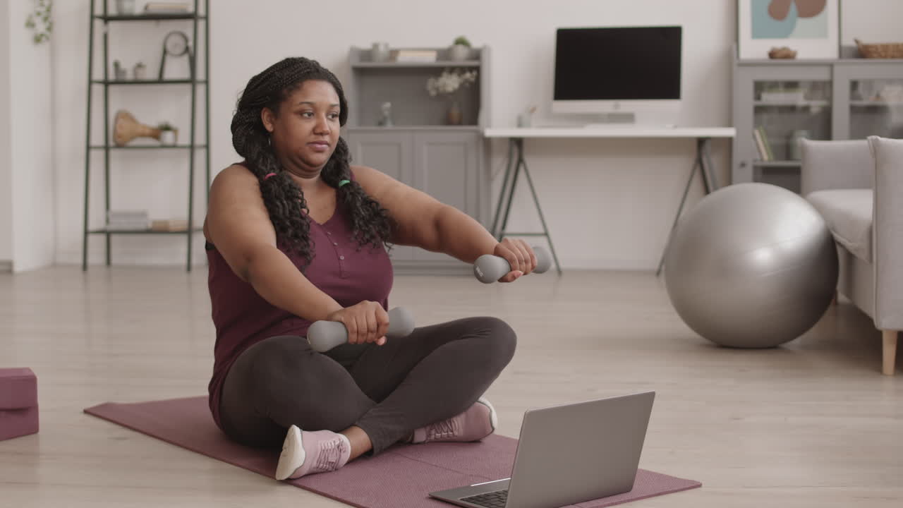 African-American Sporty Woman Having Workout by Internet