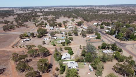 aerial view of a very small town in the outback of australia, showing roads and homes below