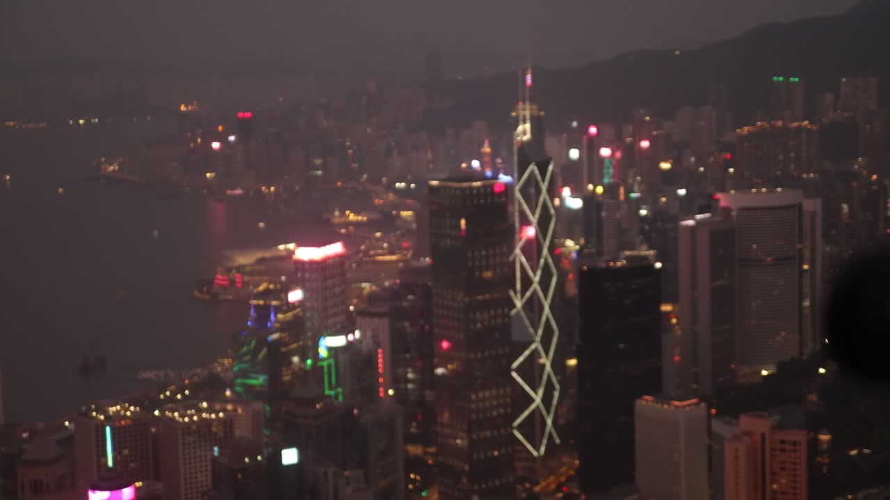 Progressive focus shot of Hong Kong city illuminated at night.